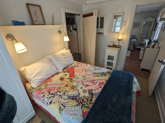 bedroom featuring crown molding and wood-type flooring