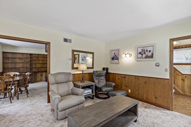living room featuring a wainscoted wall and wooden walls
