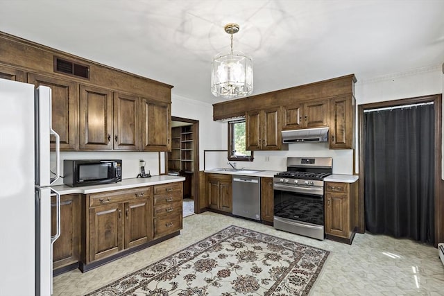 kitchen featuring appliances with stainless steel finishes, exhaust hood, light countertops, crown molding, and pendant lighting