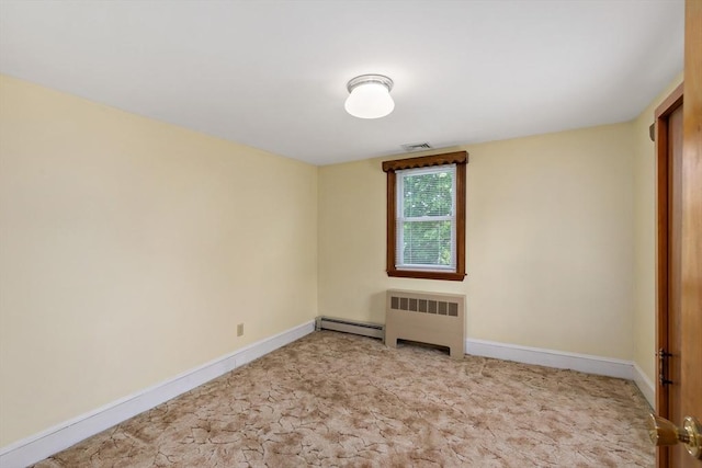 spare room with radiator heating unit, a baseboard heating unit, baseboards, and carpet