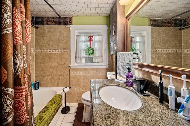 bathroom with toilet, tile walls, shower / bath combo, and vanity