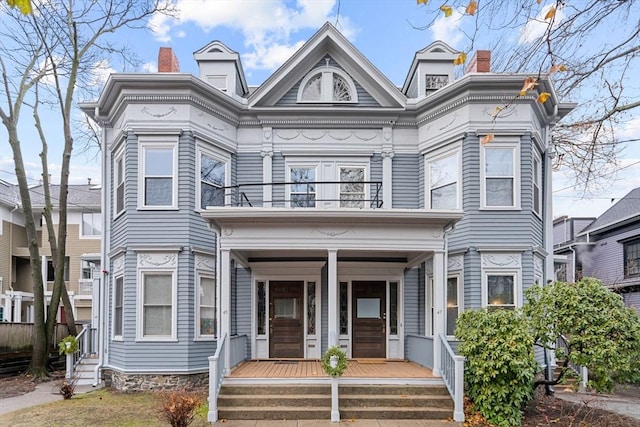 view of front of house featuring covered porch and a balcony