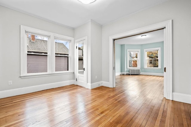 unfurnished room featuring light wood-type flooring and radiator