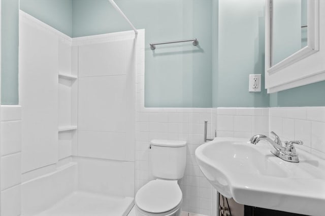 bathroom with a shower, toilet, tile walls, and sink