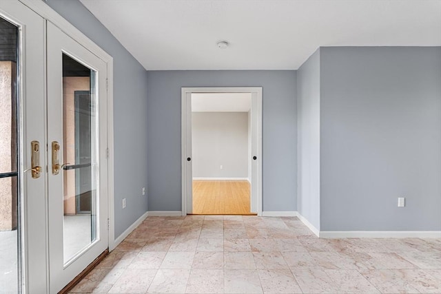 unfurnished room with baseboards