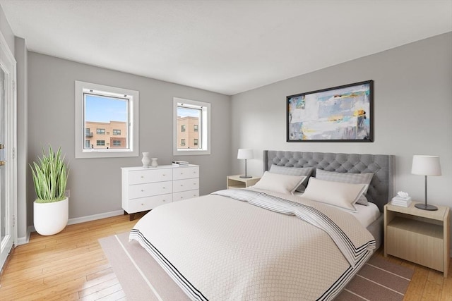 bedroom featuring light wood-type flooring and baseboards