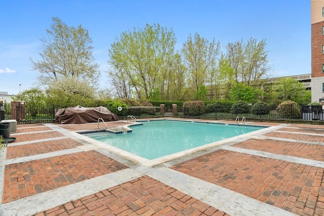 pool featuring a patio area and fence