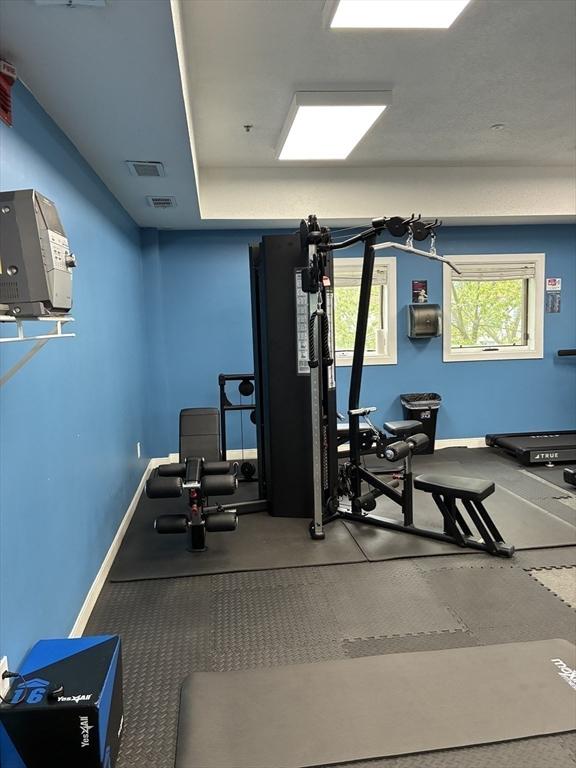 workout room with baseboards and visible vents