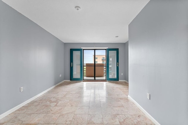 unfurnished room with baseboards