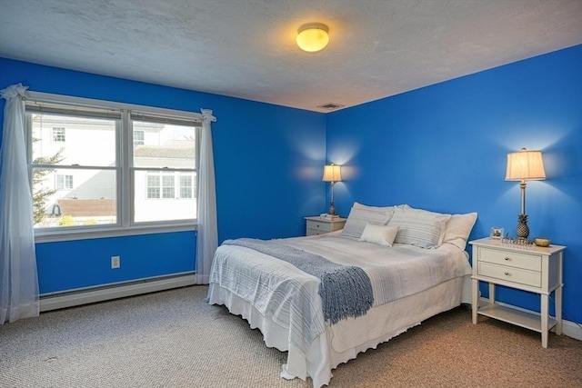 bedroom with carpet floors, a textured ceiling, and a baseboard heating unit