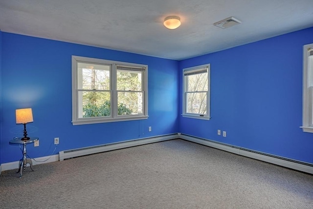 spare room featuring carpet and baseboard heating