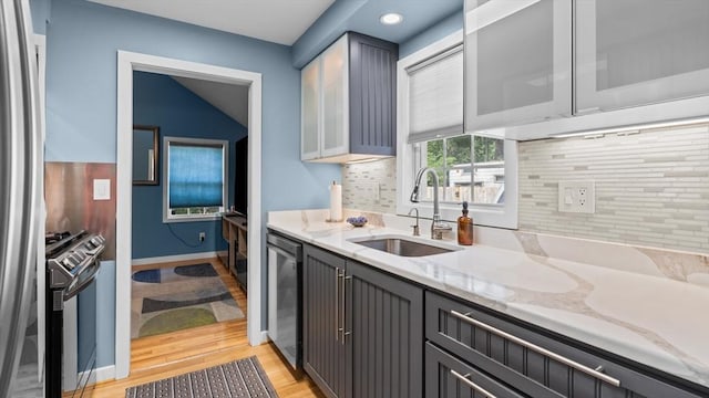 7 Grove St, Fairhaven, MA 02719 - kitchen featuring appliances with stainless steel finishes, light stone countertops, backsplash, light wood-type flooring, and recessed lighting