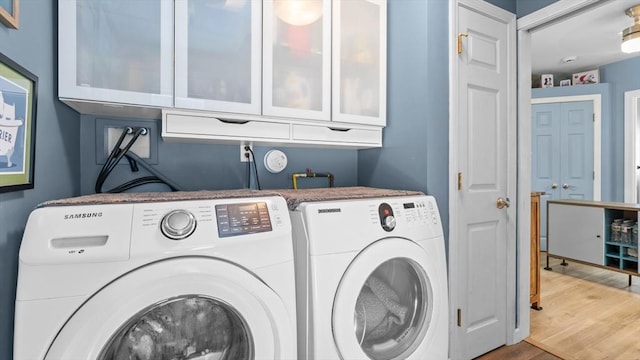7 Grove St, Fairhaven, MA 02719 - laundry area featuring independent washer and dryer, cabinet space, and wood finished floors