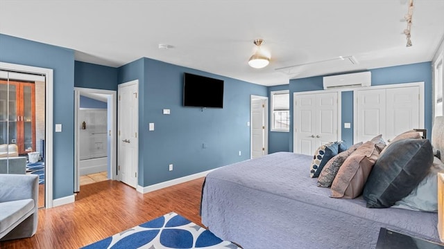 7 Grove St, Fairhaven, MA 02719 - bedroom with a wall mounted air conditioner and wood finished floors