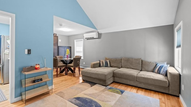 7 Grove St, Fairhaven, MA 02719 - living area with a wall unit AC, lofted ceiling, light wood-style flooring, and a baseboard radiator