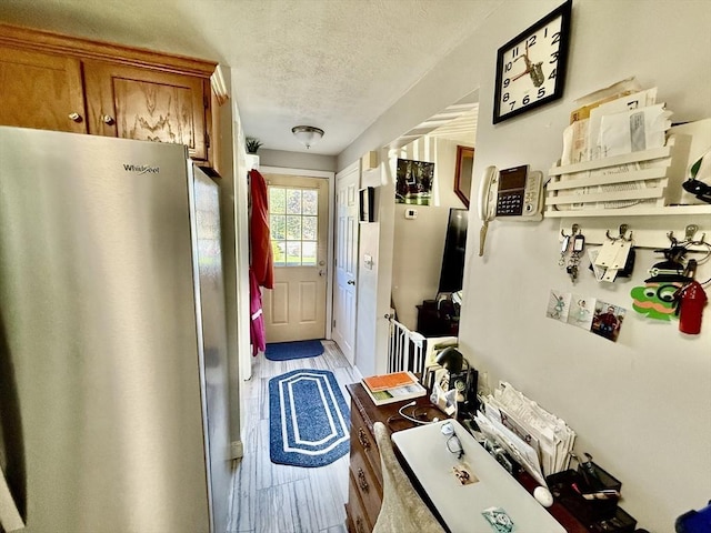 mudroom featuring a textured ceiling