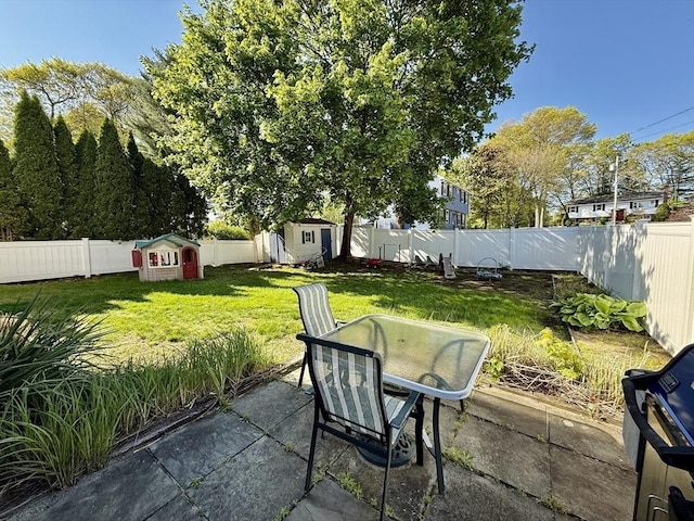 view of patio / terrace featuring a storage unit and an outbuilding