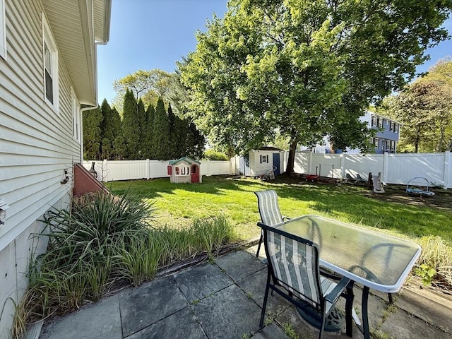 view of patio with a shed, an outdoor structure, and outdoor dining area