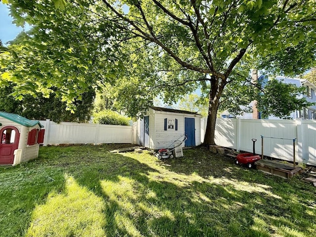 view of yard featuring a storage shed and an outbuilding
