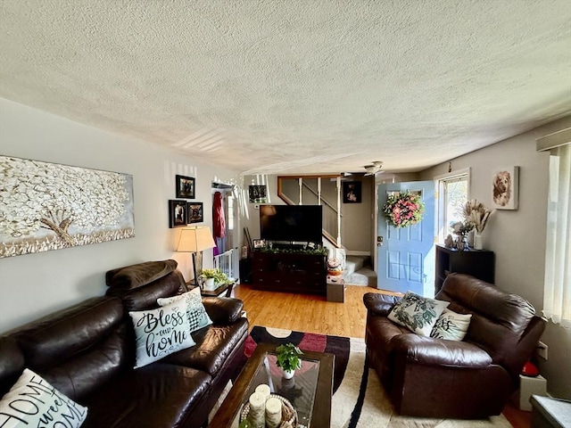 living room featuring a textured ceiling and wood finished floors