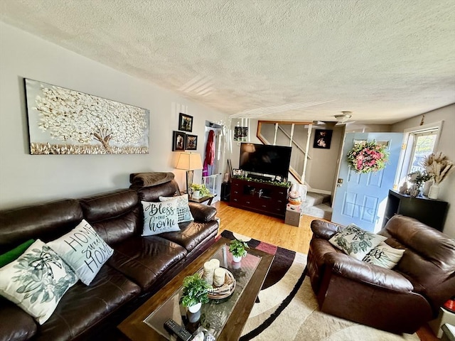 living area with wood finished floors and a textured ceiling