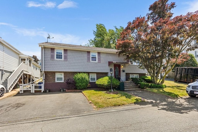 97 Marshall St, Revere, MA 02151 - bi-level home featuring brick siding, a front lawn, and stairs