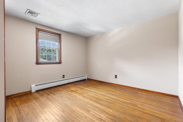 97 Marshall St, Revere, MA 02151 - empty room featuring a baseboard radiator, light wood finished floors, and a textured ceiling