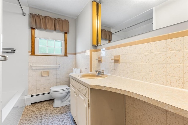 97 Marshall St, Revere, MA 02151 - bathroom with baseboard heating, vanity, tile walls, and wainscoting