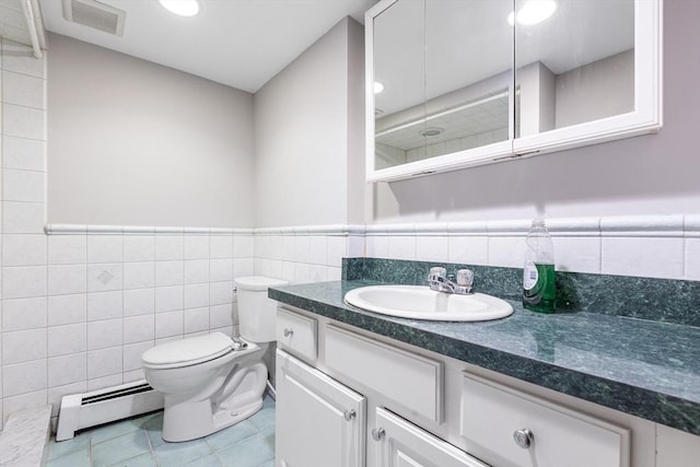 97 Marshall St, Revere, MA 02151 - full bathroom featuring a baseboard radiator, tile walls, vanity, tile patterned floors, and a wainscoted wall