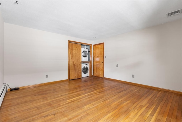 97 Marshall St, Revere, MA 02151 - spare room featuring stacked washing machine and dryer and wood-type flooring