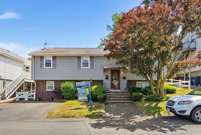 97 Marshall St, Revere, MA 02151 - bi-level home with brick siding and roof with shingles