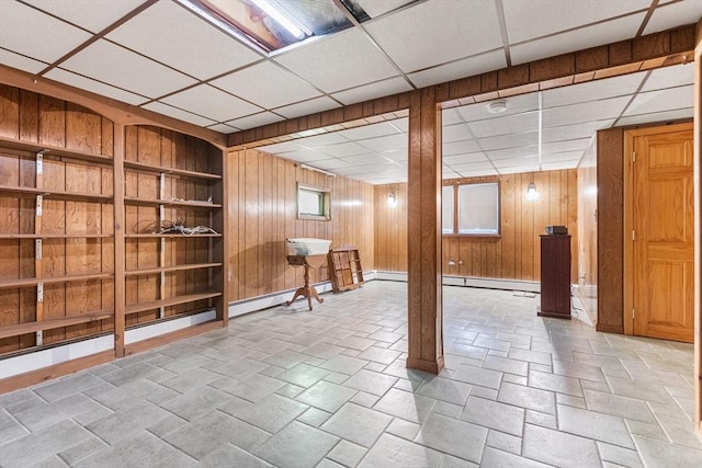 97 Marshall St, Revere, MA 02151 - finished basement featuring a baseboard radiator, a drop ceiling, and wood walls