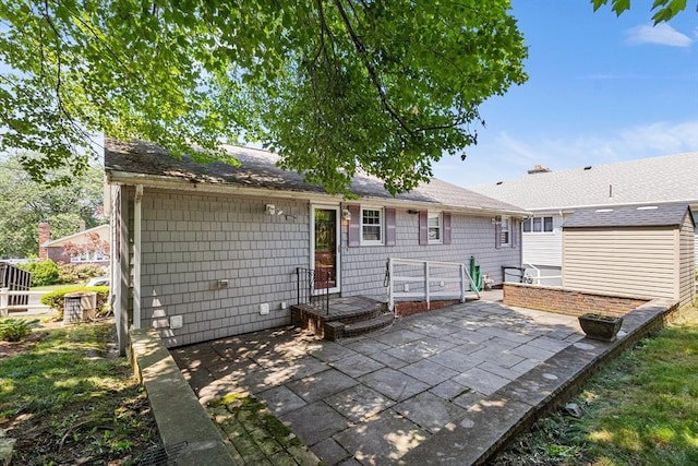 97 Marshall St, Revere, MA 02151 - back of property with a patio and a storage unit