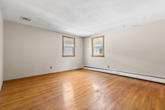 97 Marshall St, Revere, MA 02151 - spare room featuring a baseboard radiator, a textured ceiling, and light wood-style floors