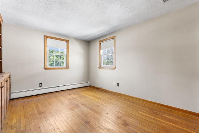 97 Marshall St, Revere, MA 02151 - empty room featuring baseboard heating, a textured ceiling, and light wood-type flooring