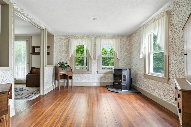 114 Center St, Carver, MA 02330 - sitting room featuring wallpapered walls, hardwood / wood-style floors, heating unit, healthy amount of natural light, and a textured ceiling