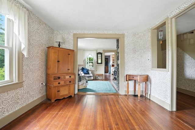 114 Center St, Carver, MA 02330 - spare room with wallpapered walls and hardwood / wood-style flooring