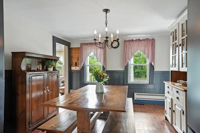 114 Center St, Carver, MA 02330 - dining room featuring a baseboard heating unit, a chandelier, wainscoting, and brick patterned floors