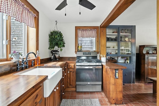 114 Center St, Carver, MA 02330 - kitchen with gas stove, wood counters, brick patterned flooring, and healthy amount of natural light
