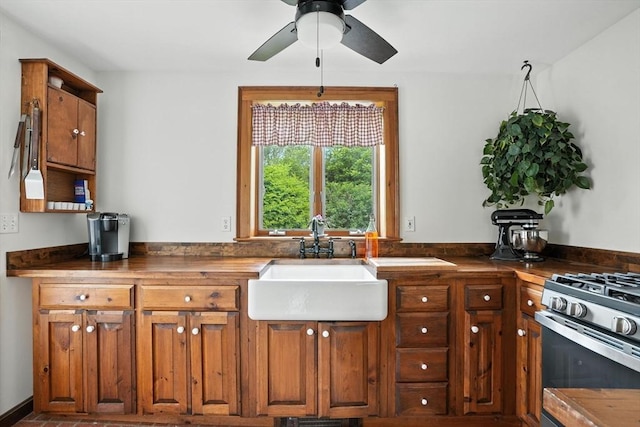 114 Center St, Carver, MA 02330 - kitchen featuring a ceiling fan, brown cabinets, stainless steel range with gas cooktop, and butcher block counters