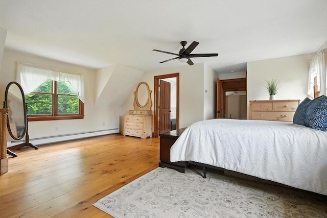 114 Center St, Carver, MA 02330 - bedroom with wood finished floors, a baseboard heating unit, and a ceiling fan