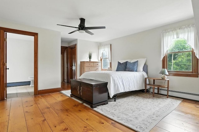 114 Center St, Carver, MA 02330 - bedroom featuring light wood-type flooring, multiple windows, baseboard heating, and a baseboard radiator