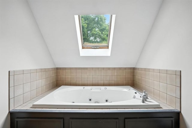 114 Center St, Carver, MA 02330 - bathroom with a tub with jets, lofted ceiling, and a skylight