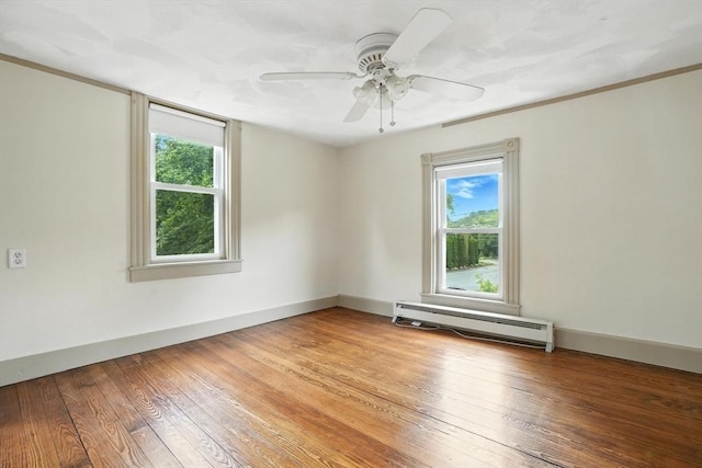 114 Center St, Carver, MA 02330 - unfurnished room featuring a baseboard radiator, plenty of natural light, ceiling fan, and wood finished floors