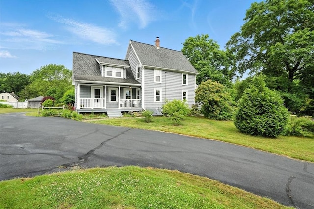 114 Center St, Carver, MA 02330 - view of front of house featuring a porch, a chimney, a shingled roof, and a front yard