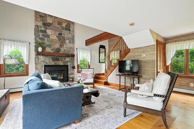 114 Center St, Carver, MA 02330 - living area with plenty of natural light, stairs, wood finished floors, and a stone fireplace