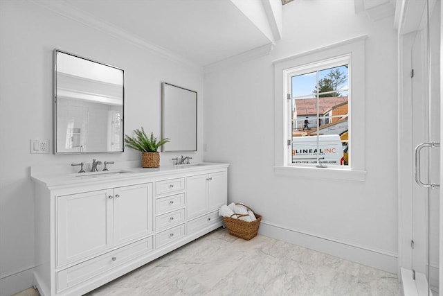 full bath with marble finish floor, baseboards, ornamental molding, and a sink