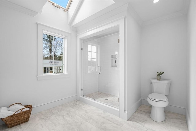 full bathroom featuring marble finish floor, ornamental molding, a skylight, a shower stall, and baseboards