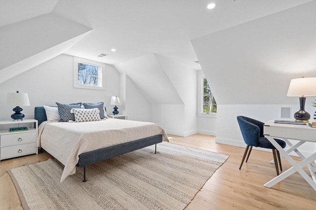 bedroom with recessed lighting, multiple windows, light wood-style flooring, and lofted ceiling