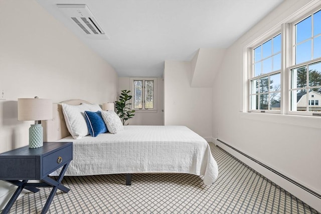 bedroom featuring a baseboard heating unit, multiple windows, lofted ceiling, and visible vents